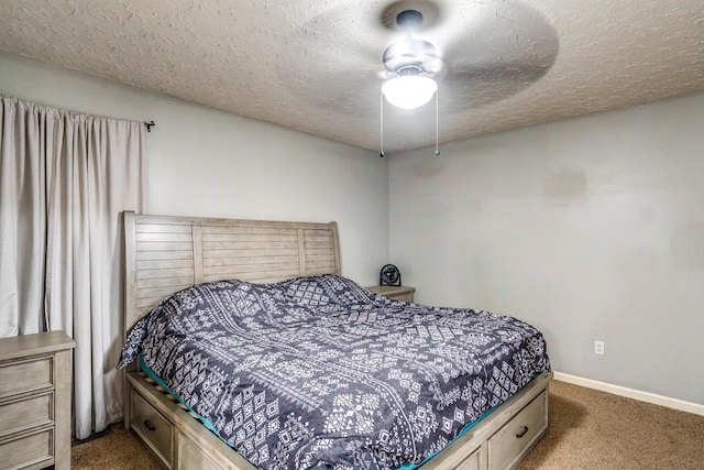 carpeted bedroom with ceiling fan and a textured ceiling