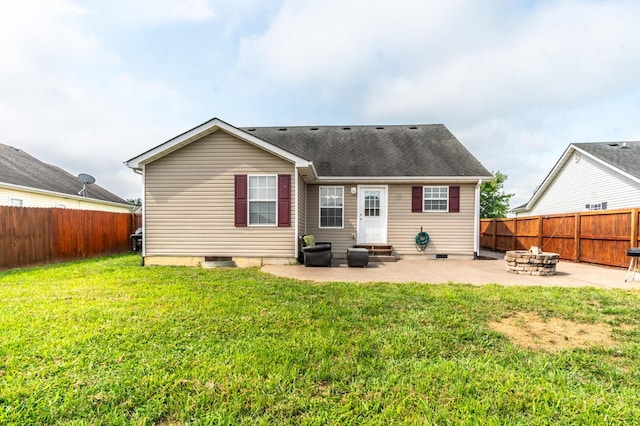 back of property featuring a lawn, a patio, and an outdoor fire pit