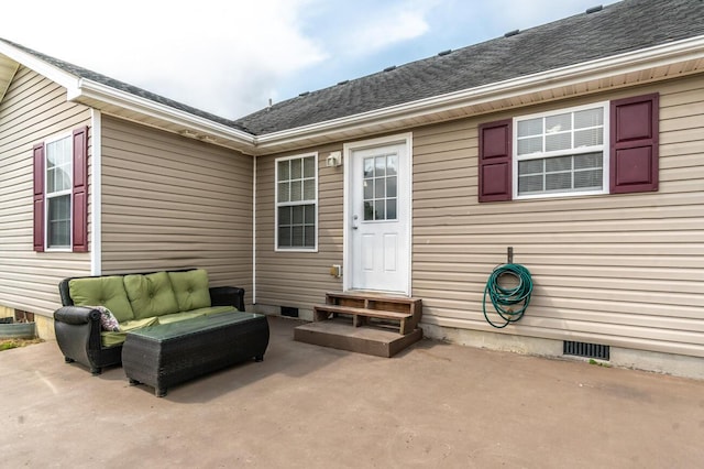 entrance to property featuring outdoor lounge area and a patio