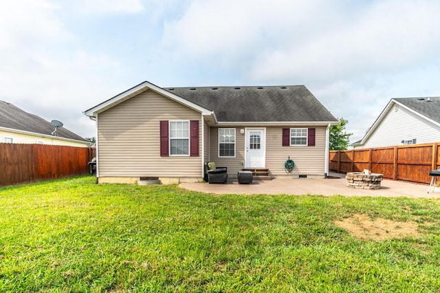 back of house featuring a yard, a patio, and an outdoor fire pit