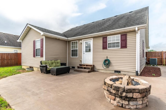 rear view of house featuring central AC unit, a patio, and an outdoor living space with a fire pit