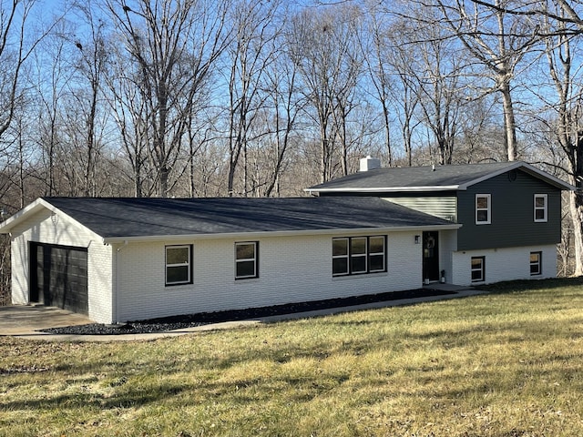 view of front of house with a garage and a front yard