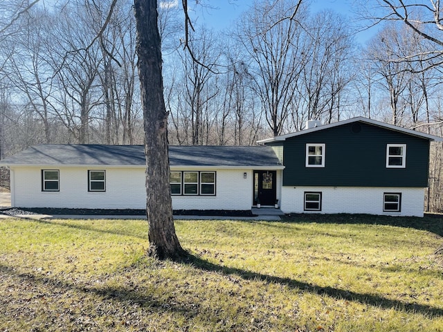 split level home featuring a front lawn