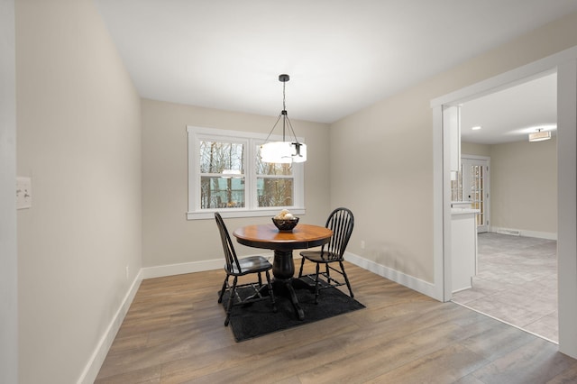 dining space with light hardwood / wood-style floors