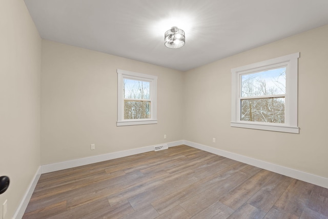 unfurnished room featuring hardwood / wood-style floors