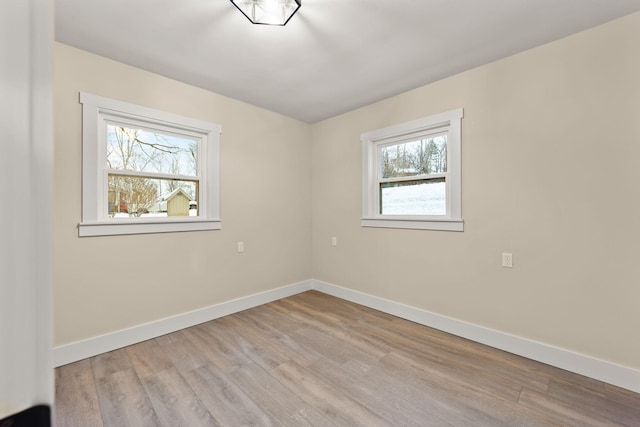 empty room with plenty of natural light and light wood-type flooring