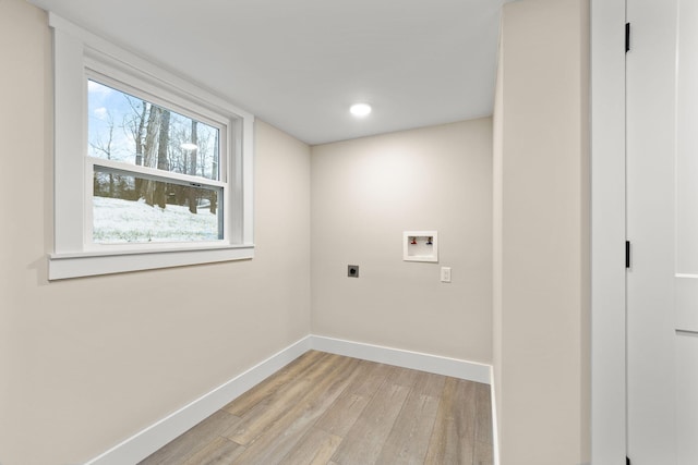 washroom with electric dryer hookup, washer hookup, and light hardwood / wood-style floors