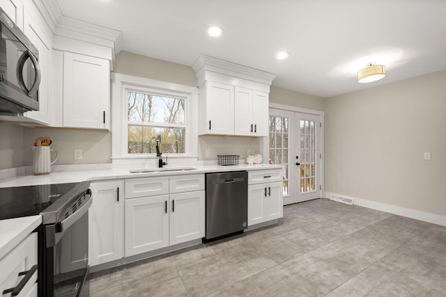 kitchen with range with electric cooktop, sink, white cabinets, stainless steel dishwasher, and french doors