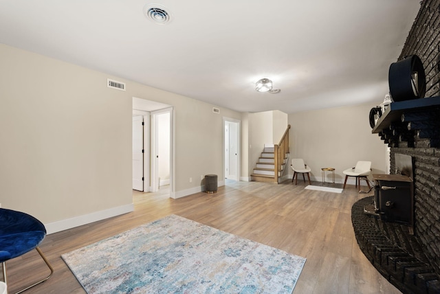 sitting room featuring a fireplace and light hardwood / wood-style floors