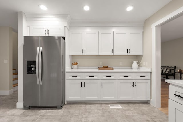 kitchen with white cabinetry and stainless steel fridge with ice dispenser