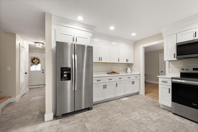 kitchen featuring white cabinetry and appliances with stainless steel finishes