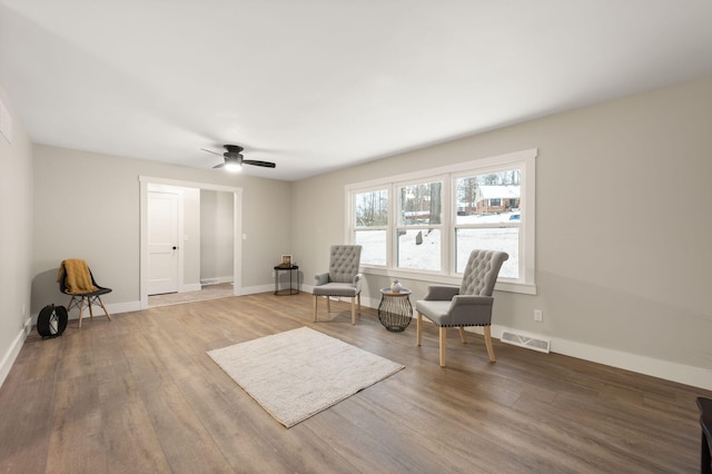 sitting room with hardwood / wood-style flooring and ceiling fan