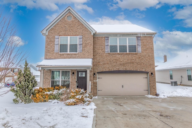 view of front of home featuring a garage and central air condition unit