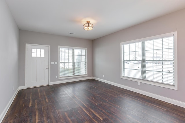 entryway with a healthy amount of sunlight and dark hardwood / wood-style floors