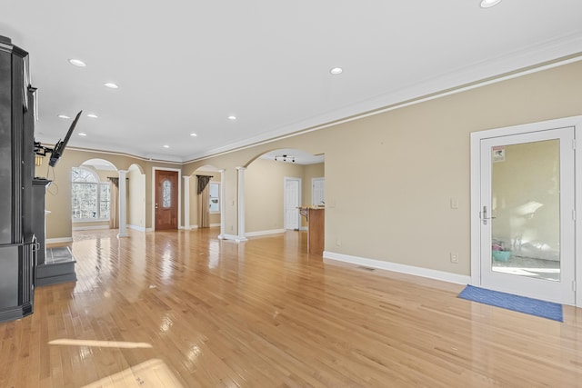 unfurnished living room featuring crown molding and light hardwood / wood-style flooring