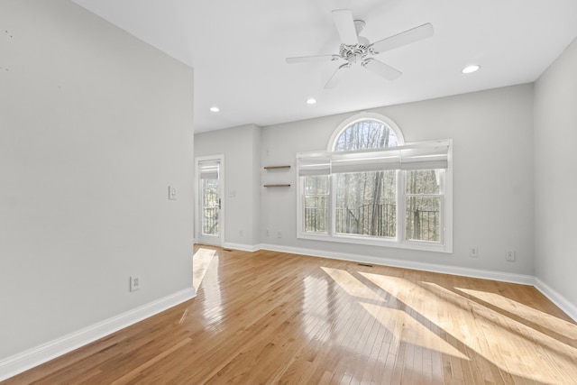 unfurnished living room with ceiling fan and light wood-type flooring