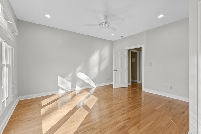 spare room with ceiling fan and light wood-type flooring