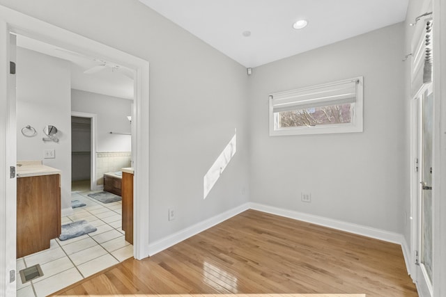 empty room featuring ceiling fan and light hardwood / wood-style floors