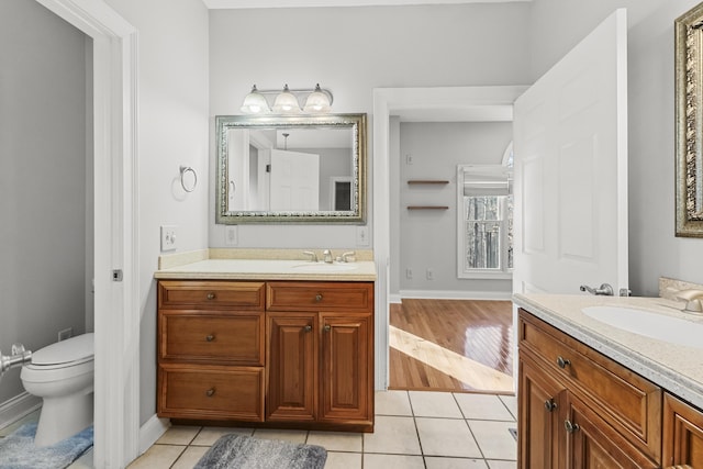 bathroom featuring tile patterned floors, vanity, and toilet