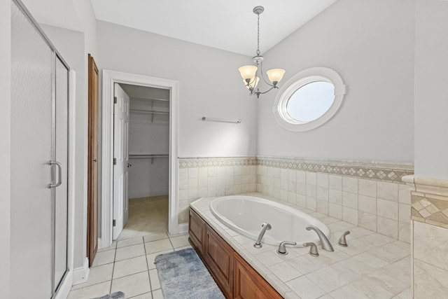 bathroom with tile patterned floors, an inviting chandelier, independent shower and bath, and vaulted ceiling