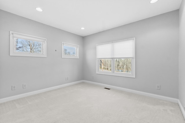 unfurnished room featuring light colored carpet