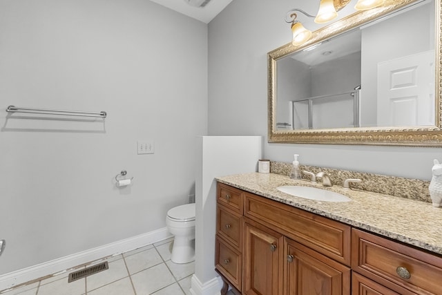 bathroom featuring tile patterned flooring, vanity, a shower with shower door, and toilet