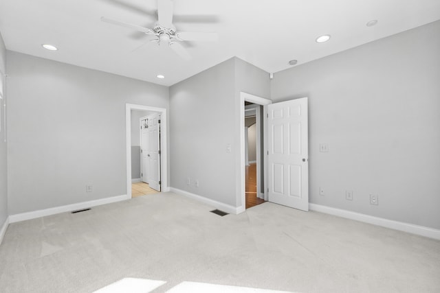 unfurnished bedroom with light colored carpet and ceiling fan