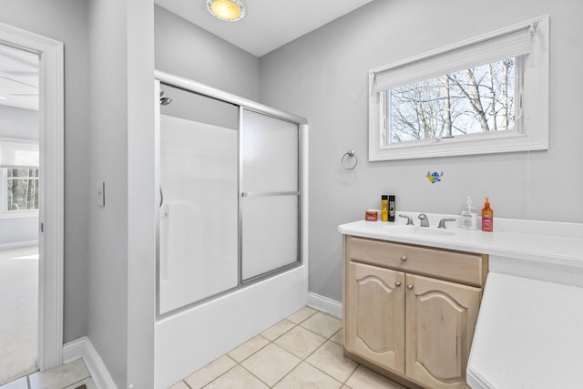 bathroom with tile patterned floors, vanity, enclosed tub / shower combo, and a wealth of natural light