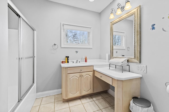 bathroom with tile patterned flooring, vanity, and enclosed tub / shower combo