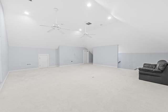 additional living space featuring ceiling fan, light colored carpet, and vaulted ceiling