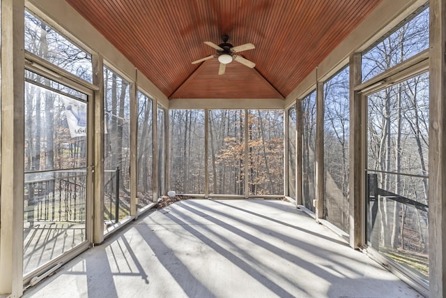 unfurnished sunroom featuring vaulted ceiling, ceiling fan, and wooden ceiling