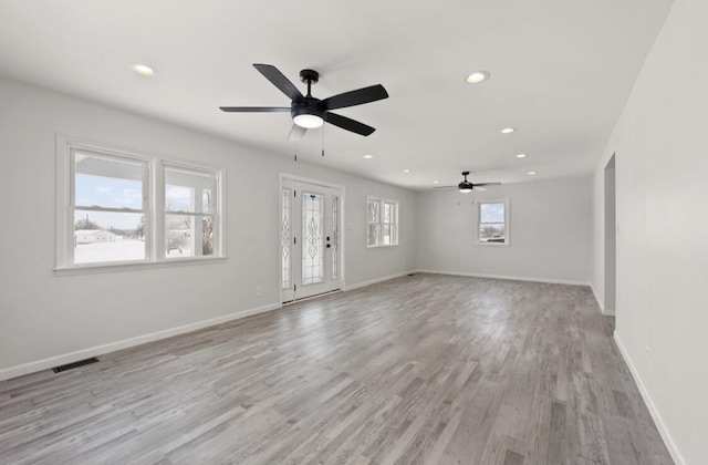 spare room featuring ceiling fan and light hardwood / wood-style floors