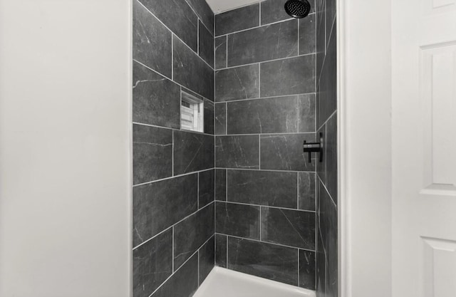 bathroom with a tile shower