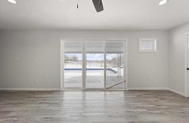 unfurnished room with ceiling fan and light wood-type flooring