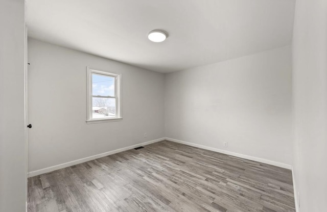 spare room with hardwood / wood-style flooring