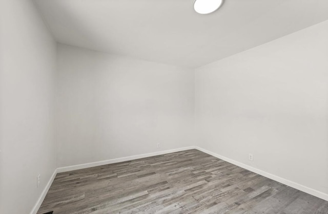 spare room featuring hardwood / wood-style flooring