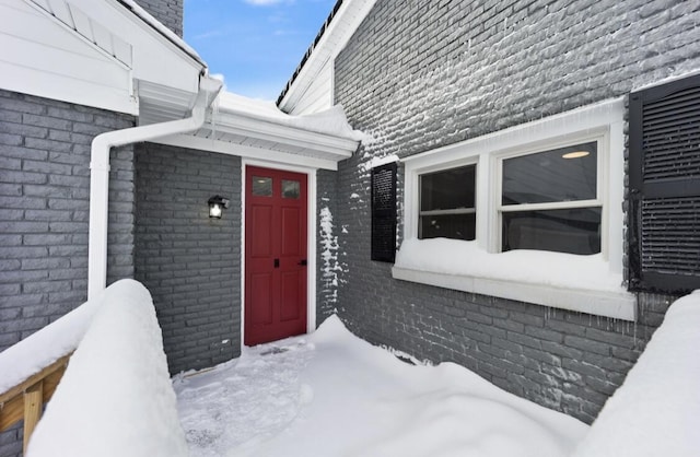 view of snow covered property entrance