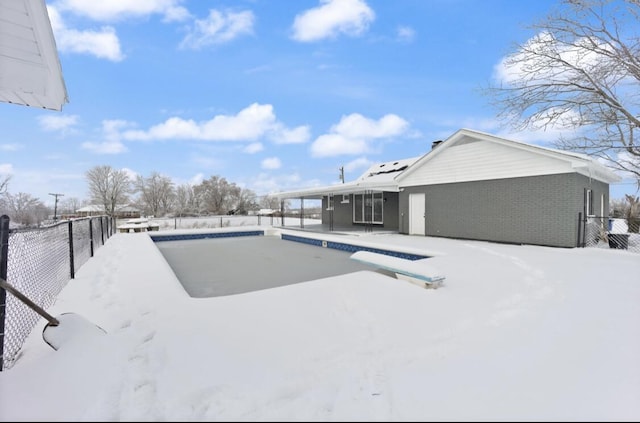 yard covered in snow featuring an empty pool and a patio area