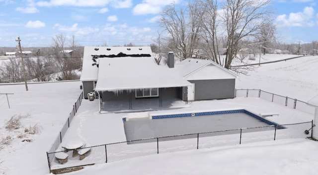 view of snow covered back of property