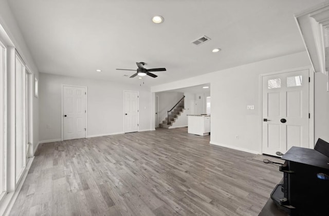 living room with ceiling fan and light wood-type flooring