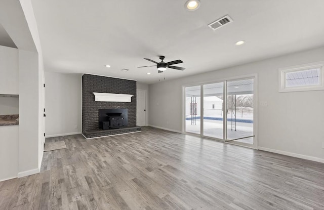 unfurnished living room featuring ceiling fan and light hardwood / wood-style flooring