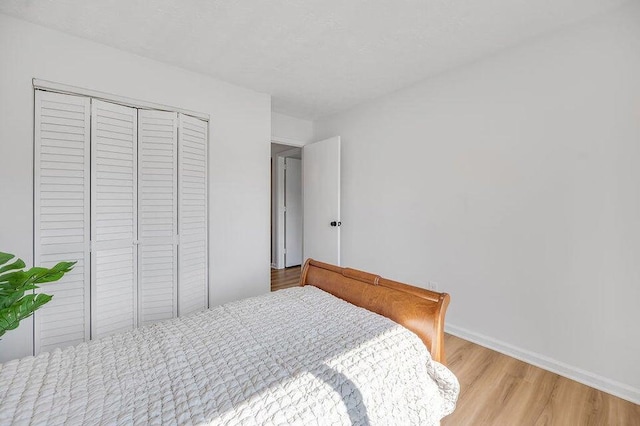 bedroom with a closet and light wood-type flooring