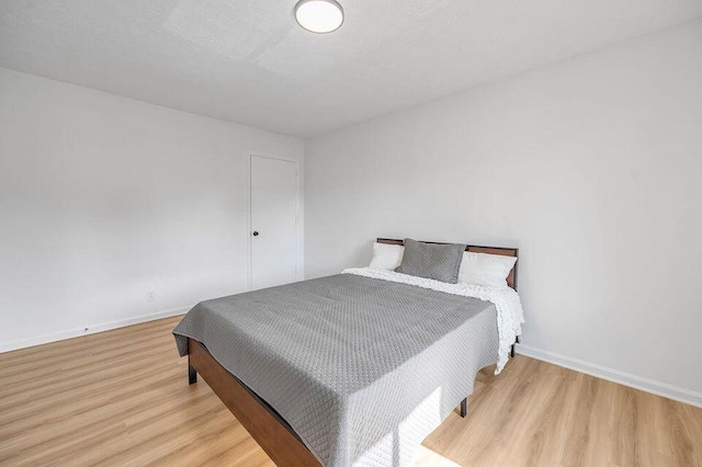 bedroom with light hardwood / wood-style floors