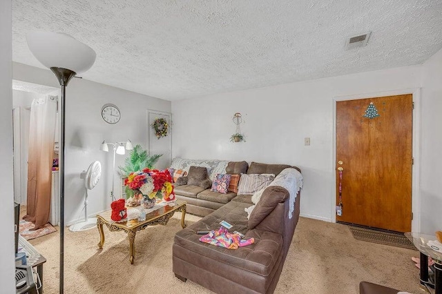 living room featuring carpet and a textured ceiling