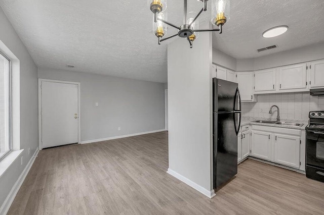 kitchen with backsplash, a textured ceiling, sink, black appliances, and white cabinetry