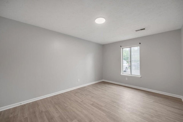 empty room with light hardwood / wood-style floors