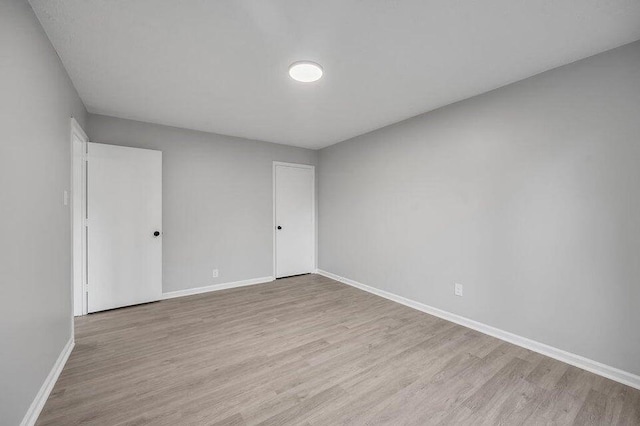 spare room with light hardwood / wood-style floors