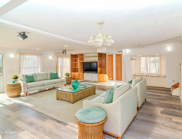 living room with hardwood / wood-style floors and a chandelier