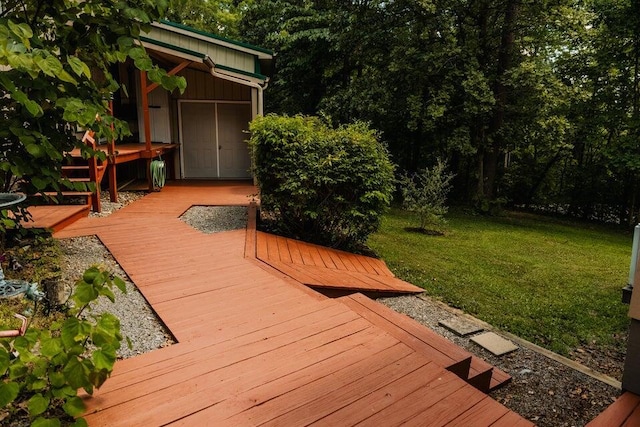 wooden terrace featuring a yard