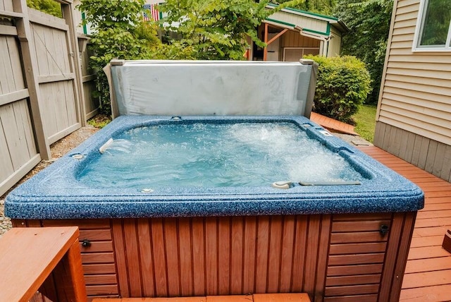 wooden terrace featuring a covered hot tub